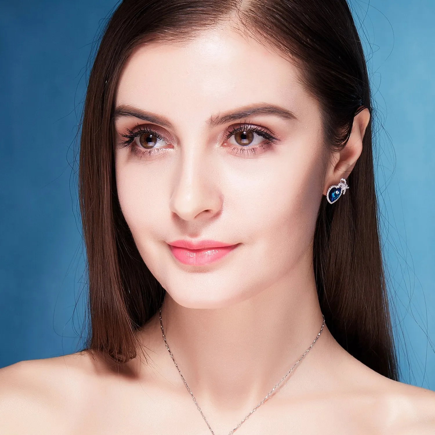 Sterling silver blue topaz heart with a bow earring